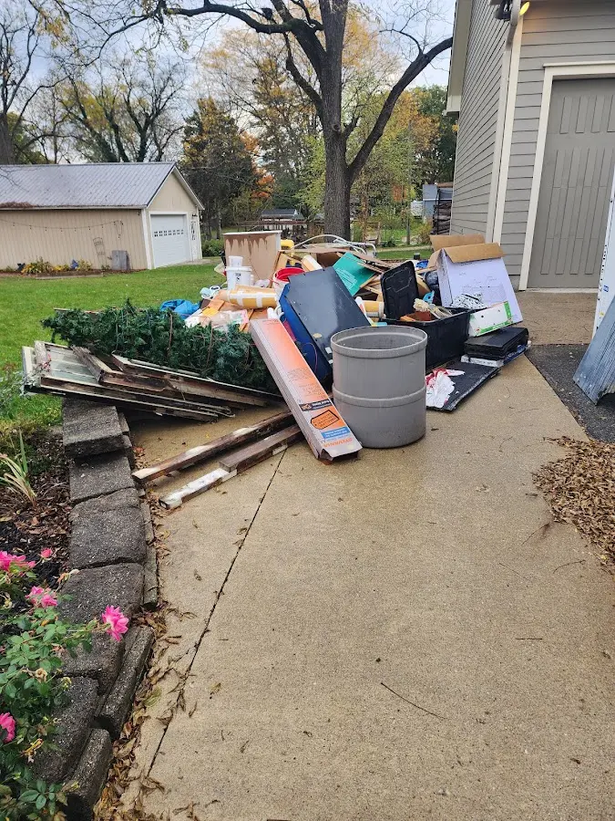 Dumpster being loaded with debris for 12 Yard Dumpster Rental in Millstone